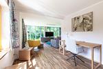 Heller Wohnraum mit Sofa und Schreibtisch - Haus Traudi - Top-Hundeurlaub