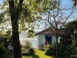 Blick auf Garten und See - Ferienwohnung Idylle am See - Top-Hundeurlaub