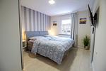 Schlafzimmer der Nautic Lounge – Beach House 1 mit Boxspringbett, Flat-TV und gemütlichem Ambiente. - Nautic Lounge  - Beach House 1 - Top-Hundeurlaub