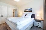 Schlafzimmer mit Boxspringbett und Kleiderschrank - Aparthotel Ostseeallee 4-31 - Top-Hundeurlaub