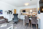 Wohn-/Essbereich mit Couchtisch, Sitzgelegenheiten und Küchenzeile - Aparthotel Ostseeallee 4-35 - Top-Hundeurlaub