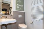 Badezimmer mit WC, Waschtisch und Spiegel - Apartmentvilla Anna See 1-07 - Top-Hundeurlaub
