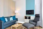 Wohn/ Essbereich mit Couch, Sessel und Fernseher - Aparthotel Anna Düne 0-03 - Top-Hundeurlaub