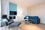 Wohn/ Essbereich mit Couch, Sessel und Tisch - Aparthotel Anna Düne 2-36 - Top-Hundeurlaub