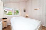 erstes Schlafzimmer mit Doppelbett - Ferienhaus 19 - Top-Hundeurlaub