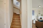 Treppenaufgang zum Obergeschoss mit Blick ins Wohnzimmer - Reethaus 15b - Top-Hundeurlaub