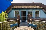 Terrasse mit Tisch und blauen Stühlen - Haus am Schilf - Wohnung 6 - Top-Hundeurlaub