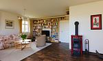 Heller Wohnraum mit Sofa und Bücherregal - Klönhus - Top-Hundeurlaub