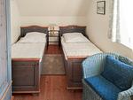 Schlafzimmer mit zwei Einzelbetten und Sessel - Worpswede - Top-Hundeurlaub