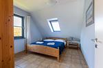 Schlafzimmer mit Doppelbett und Fenster - Strandhaus Wustrow - Wohnung 5 - Top-Hundeurlaub