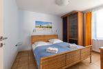 Schlafzimmer mit Doppelbett und Holz-Möbeln - Strandhaus Wustrow - Wohnung 4 - Top-Hundeurlaub