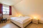 Helles Schlafzimmer mit Doppelbett und Nachttisch - An den Boddenwiesen 01 - Top-Hundeurlaub