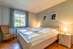 Schlafzimmer mit Doppelbett und Fensterblick - Boddenzauber 01 - Top-Hundeurlaub