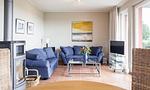 Gemütliches Wohnzimmer mit blauen Sofas und Fernseher - Boddenzauber 01 - Top-Hundeurlaub