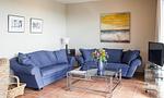 Gemütliches Wohnzimmer mit blauen Sofas und Glastisch - Boddenzauber 01 - Top-Hundeurlaub