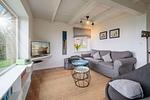 Gemütliches Wohnzimmer mit Ofen und Meerblick - Strandhaus am Mühlendamm - Top-Hundeurlaub