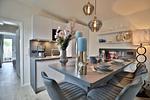 Nautic Lounge – Beach Garden: Moderne Küche mit Esstresen und Blick ins Schlafzimmer in Haffkrug. - Nautic Lounge - Beach Garden - Top-Hundeurlaub