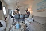 Nautic Lounge – Beach Garden: Offener Wohn- und Essbereich mit gemütlichem Sofa und moderner Küche in Haffkrug. - Nautic Lounge - Beach Garden - Top-Hundeurlaub