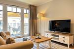 Wohnzimmer mit Blick zum Fernseher - Wohnung 39 - Top-Hundeurlaub