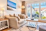 Wohnbereich mit Sitzecke und TV - Wohnung 44 - Top-Hundeurlaub