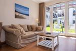 Wohnbereich mit Sitzecke und TV - Wohnung 16 - Top-Hundeurlaub