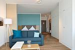 Wohn/ Essbereich mit Couch und Tisch - Aparthotel Anna Düne 2-31 - Top-Hundeurlaub