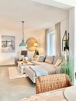 Helles Wohnzimmer mit Sofa, Tisch und dekorativen Elementen. - Ferienhaus Luke - Top-Hundeurlaub