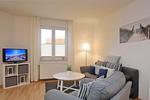 Wohnbereich mit Sitzecke und TV - Wohnung 04 -Promenadendeck - Top-Hundeurlaub
