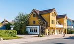 Außenansicht eines gelben Gebäudes mit Kunsthandlung - Nathalie - Top-Hundeurlaub