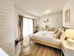 Ansicht Schlafzimmer mit Doppelbett und Smart TV - Charmantes Appartement am Hafen mit gratis Bettwäsche-Paket und Terrasse - Top-Hundeurlaub