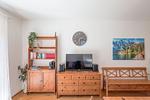 Wohnzimmer mit Sofa und Fernseher - Dachsteinblick by Alpendyll Apartments - Top-Hundeurlaub