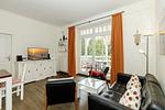 Wohn-Essbereich mit Couch und Flatscreen-TV - Dünenschloss 1-17 - Top-Hundeurlaub