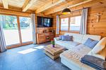 Wohnzimmer mit Sofa und Fernseher - Chalet Huber by Alpenidyll Apartments - Top-Hundeurlaub