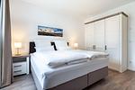 Schlafzimmer mit Boxspringbett und Kleiderschrank - Aparthotel Ostseeallee 3-19 - Top-Hundeurlaub
