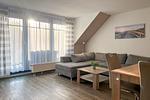 Wohnzimmer mit Zugang zum Balkon - Wohnung 07-7 - Top-Hundeurlaub