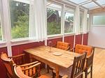 Heller Wintergarten mit großem Esstisch in der Villa Pelle - Villa Pelle - Top-Hundeurlaub
