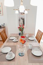 Essbereich mit gedecktem Tisch und Blumen - Berliner Hof App. 301 - Top-Hundeurlaub
